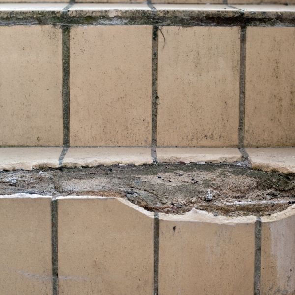 Loose and cracked floor tile needing replacement in a Pretoria home.