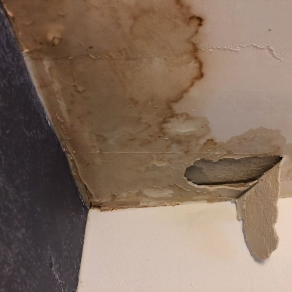 Ceiling with water stains and damage inside a Pretoria home.